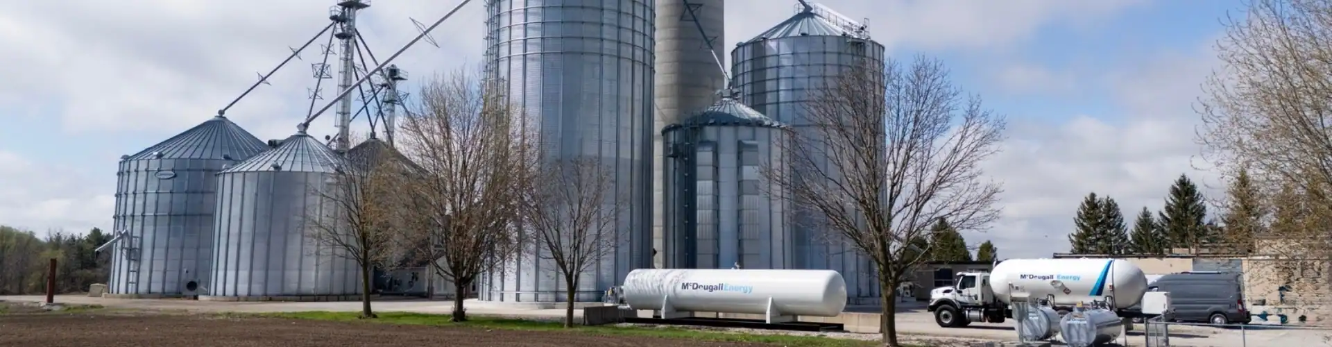 Farm silos and fuel trucks on an agricultural farm.