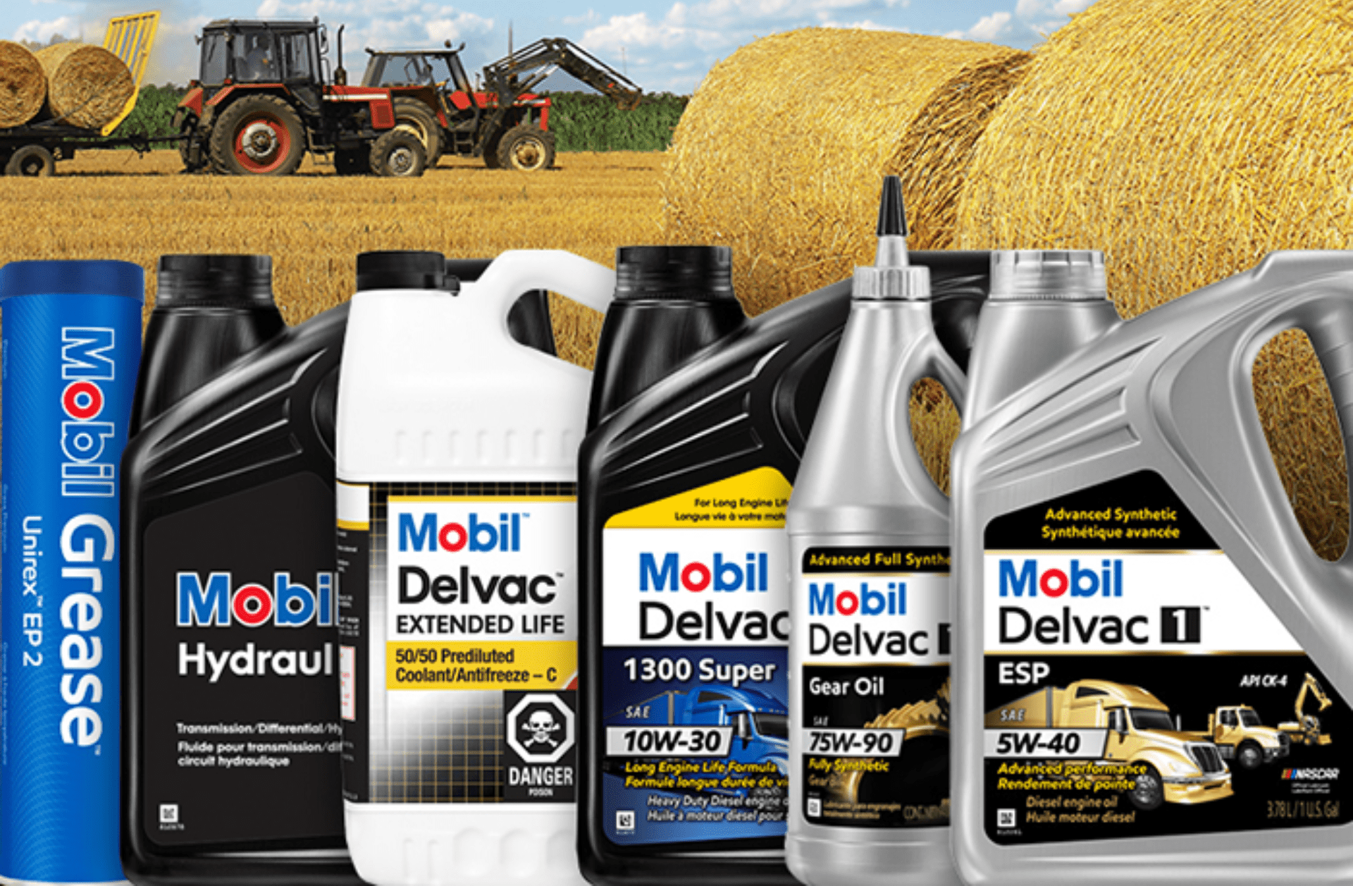 Premium Mobil Delvac engine oils for commercial and heavy-duty vehicles on a rural farm scene.