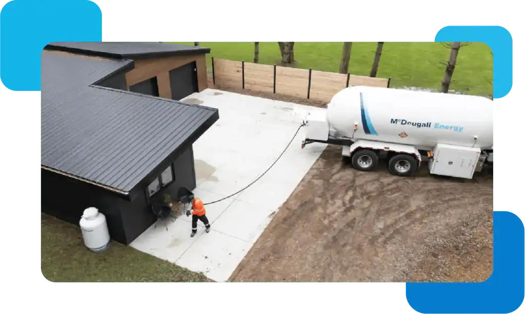 Fuel delivery truck at a modern home in a rural setting.