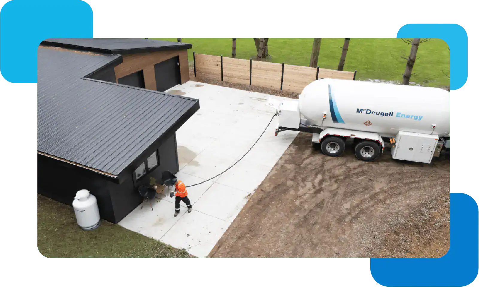 Fuel delivery truck at a modern home in a rural setting.