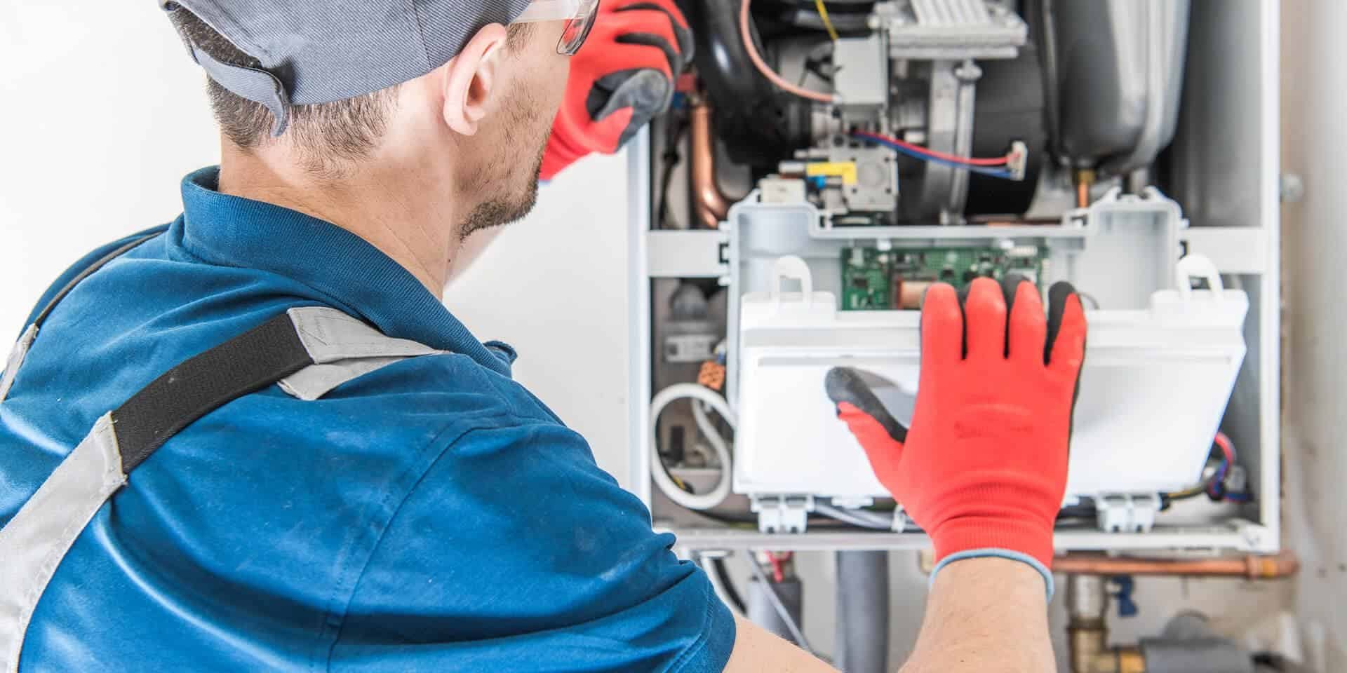 High-efficiency HVAC technician repairing heating system, energy solutions, McDougall Energy services.