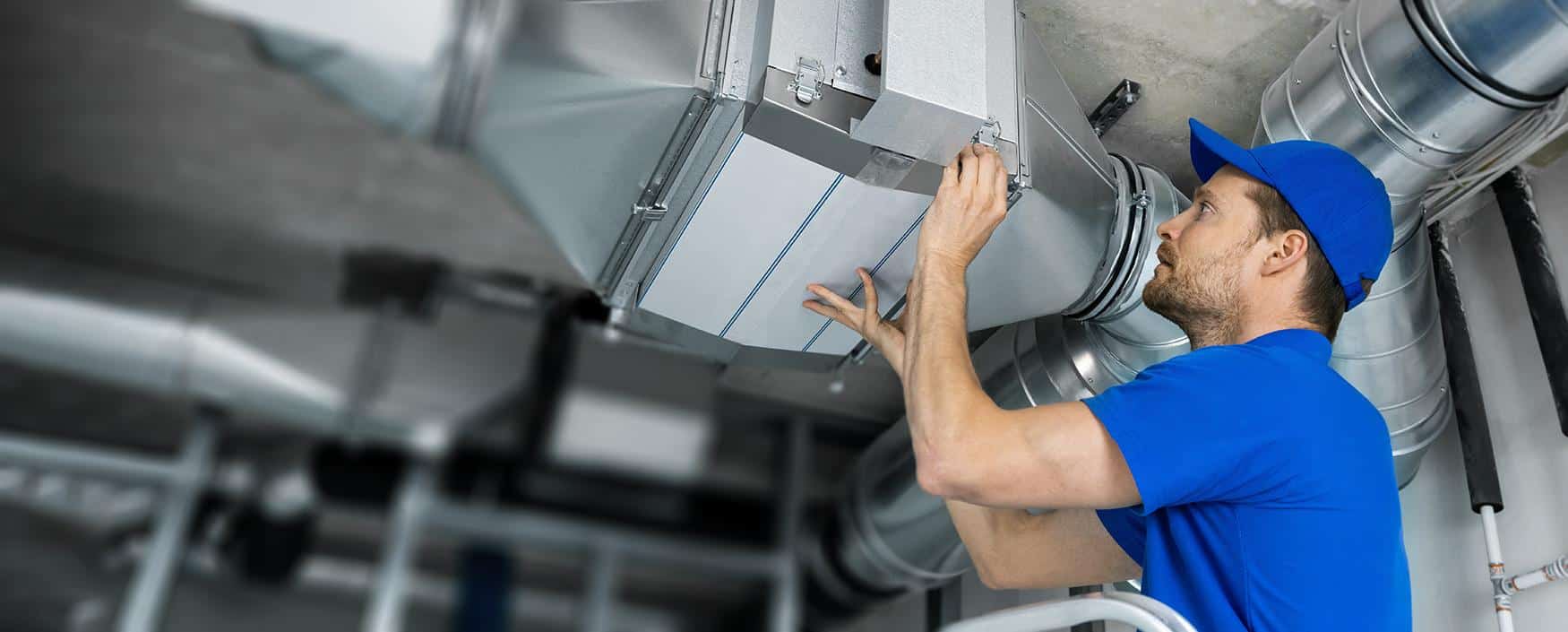 Energy technician inspecting industrial HVAC system for efficient heating and cooling solutions.